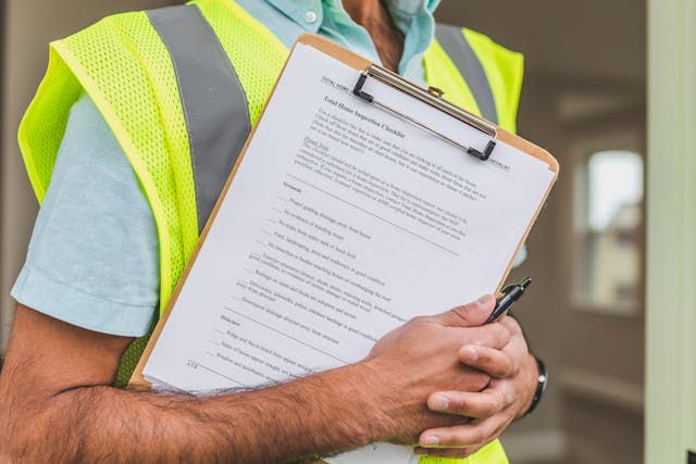person holding home inspection checklist